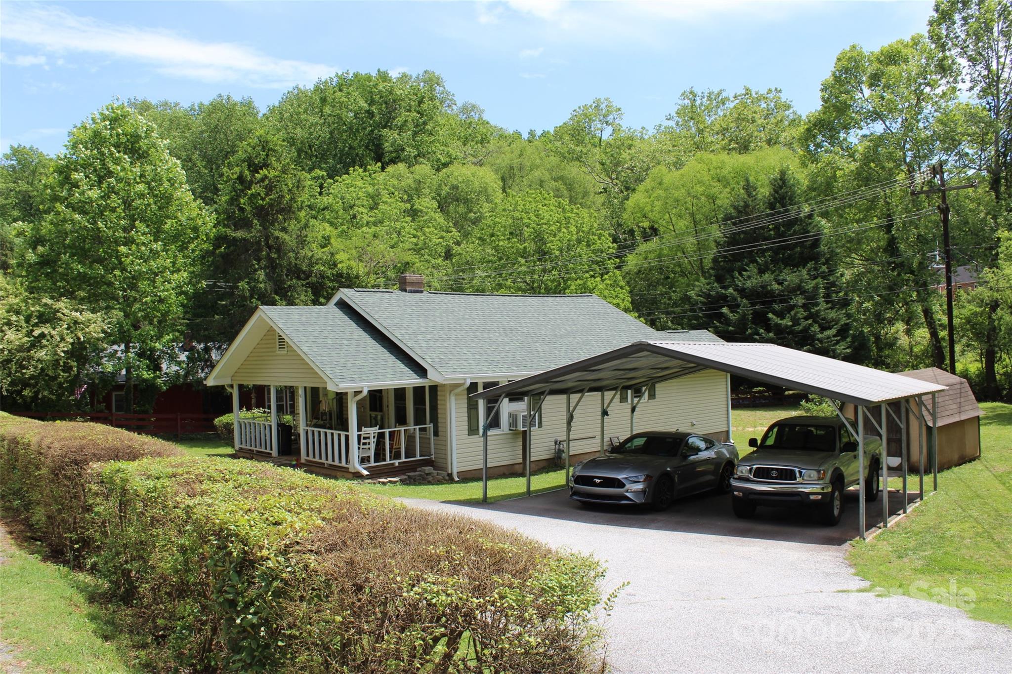68 Rector Street Tryon, NC 28782 - Photo 1 of 29 a front view of a house with a yard garden and patio