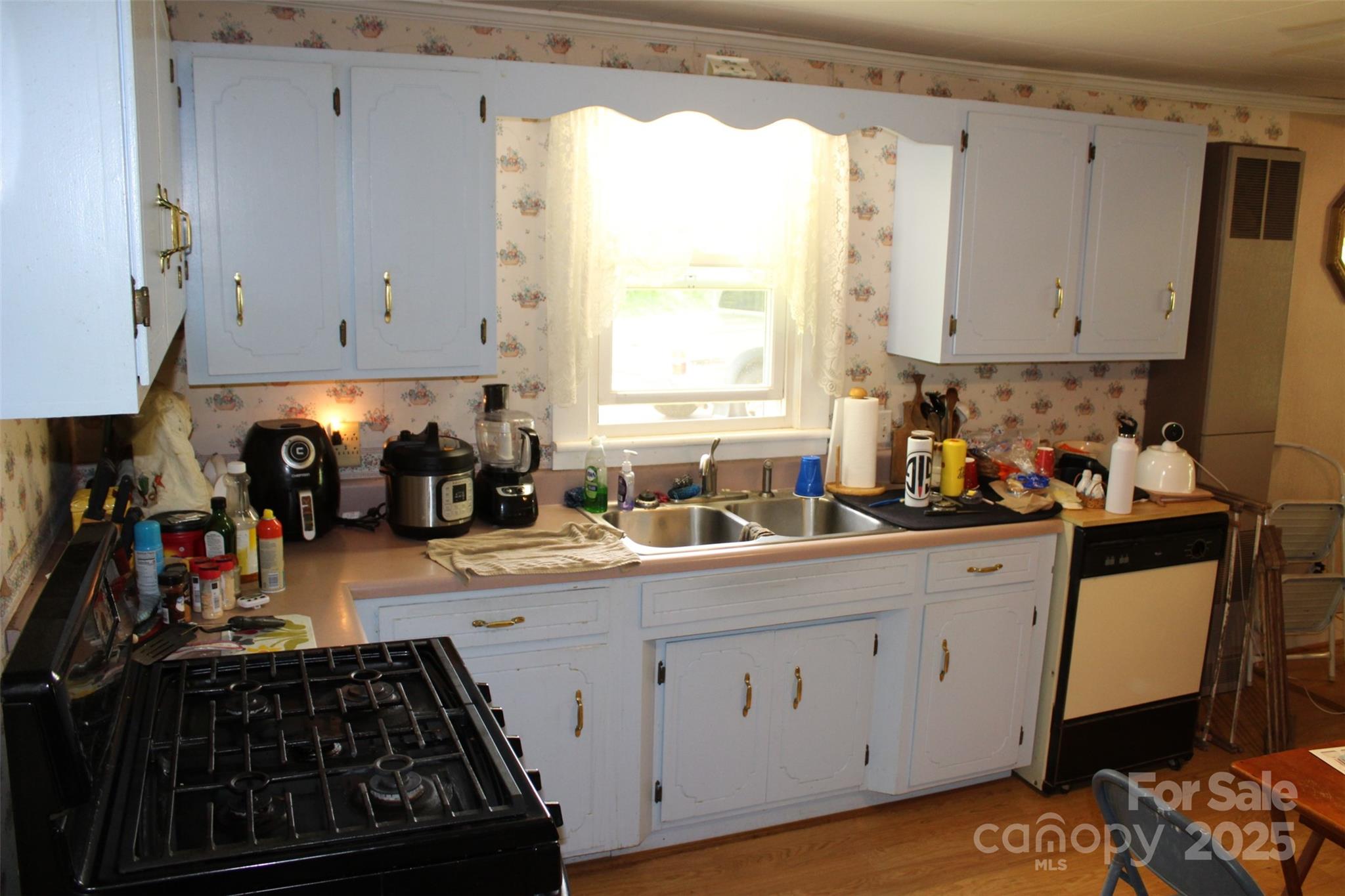 68 Rector Street Tryon, NC 28782 - Photo 12 of 29 a kitchen with sink a stove and cabinets