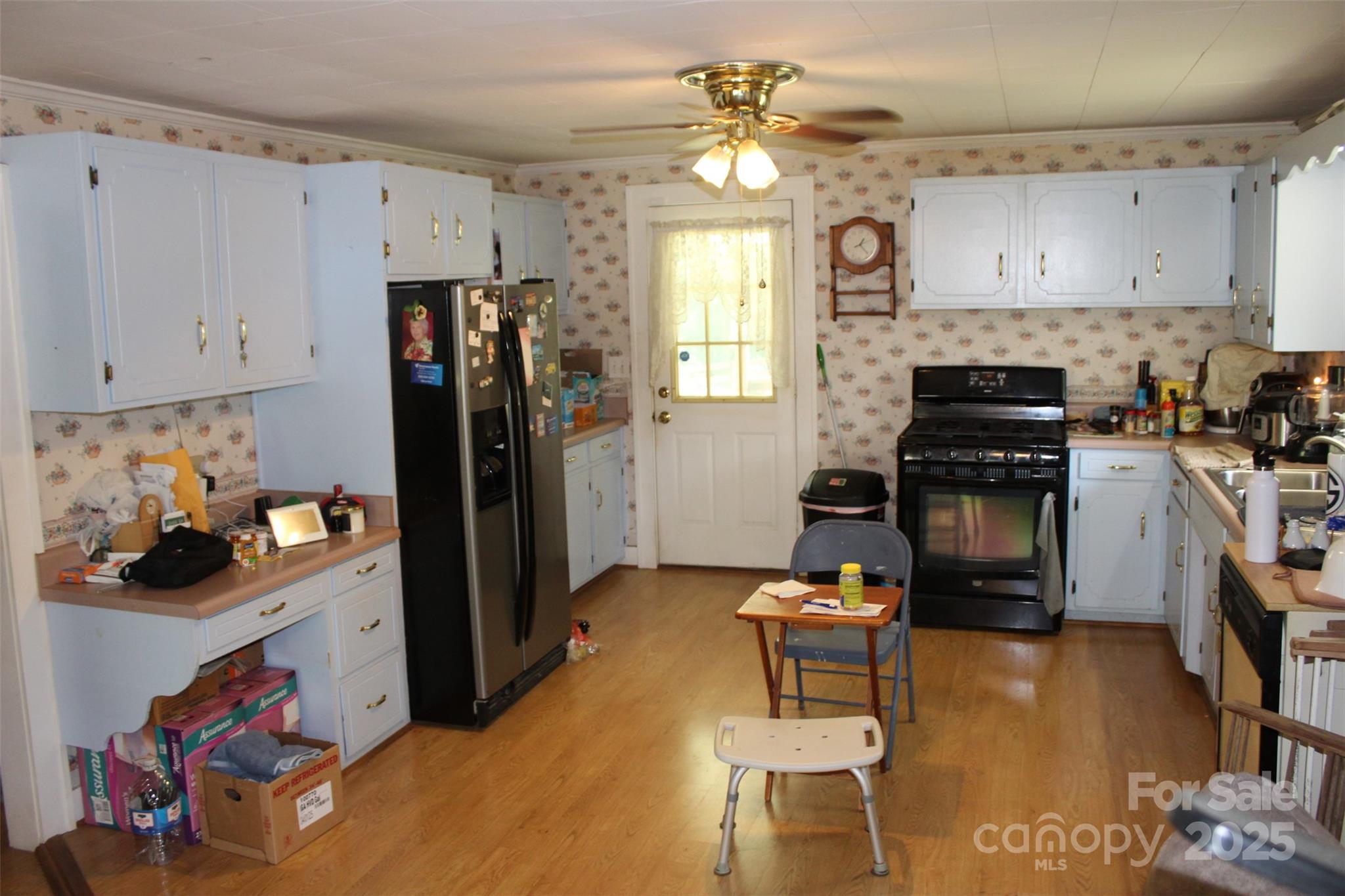 68 Rector Street Tryon, NC 28782 - Photo 13 of 29 a kitchen with a refrigerator and a stove top oven