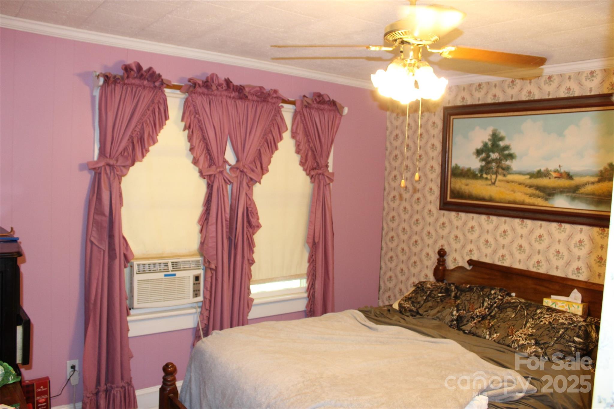 68 Rector Street Tryon, NC 28782 - Photo 18 of 29 a bedroom with a bed and a painting on the wall