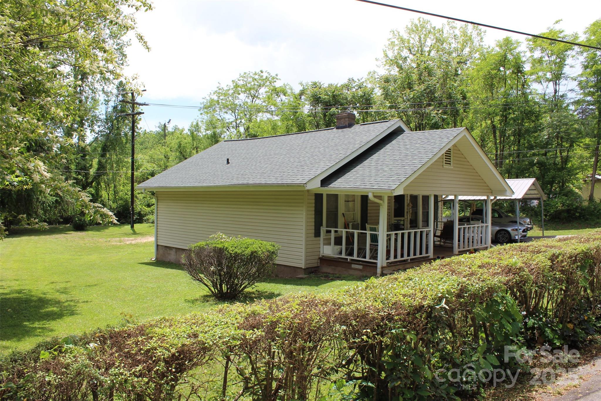 68 Rector Street Tryon, NC 28782 - Photo 3 of 29 a house with green field in front of it