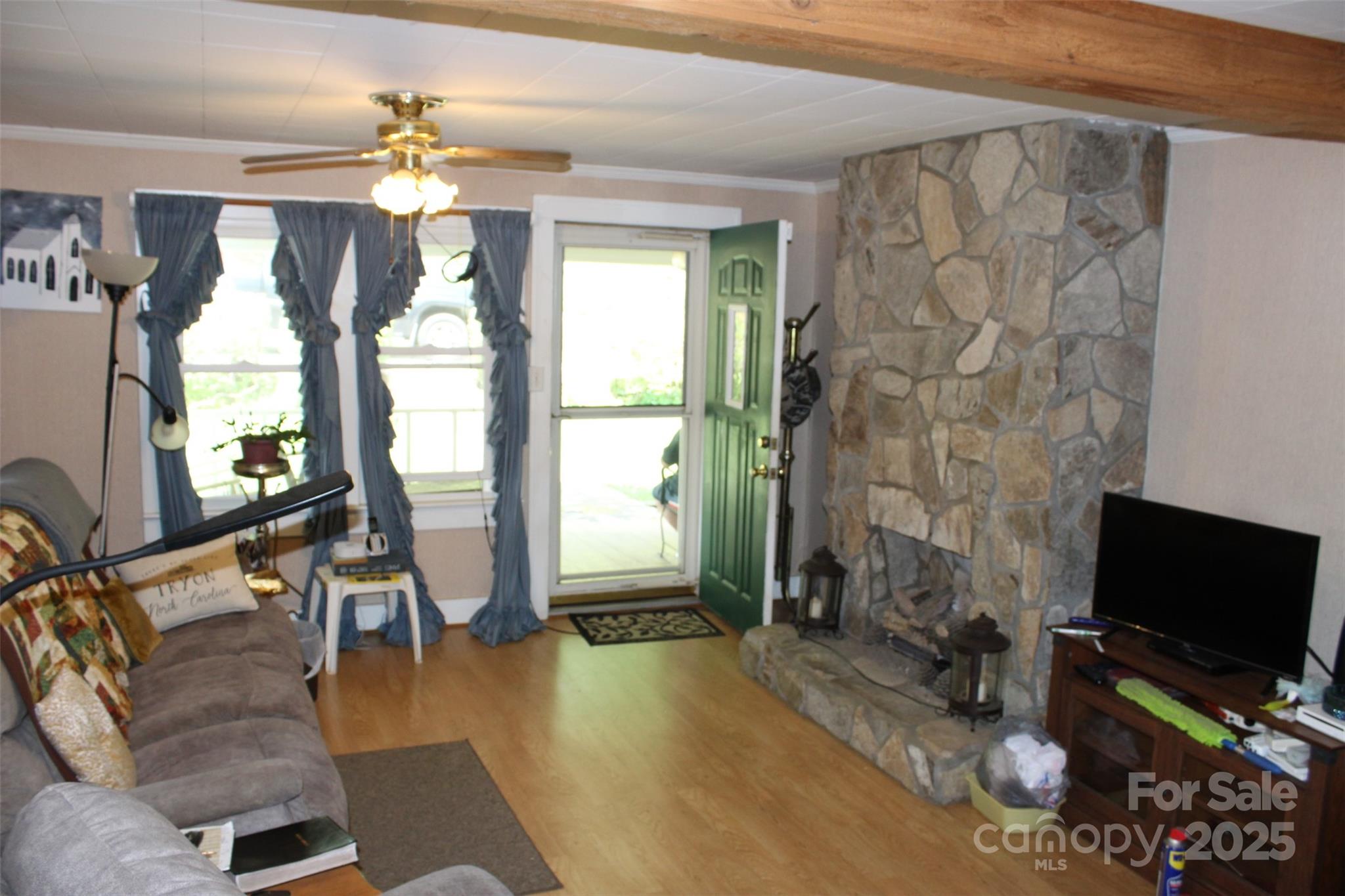 68 Rector Street Tryon, NC 28782 - Photo 10 of 29 a living room with fireplace furniture and a flat screen tv