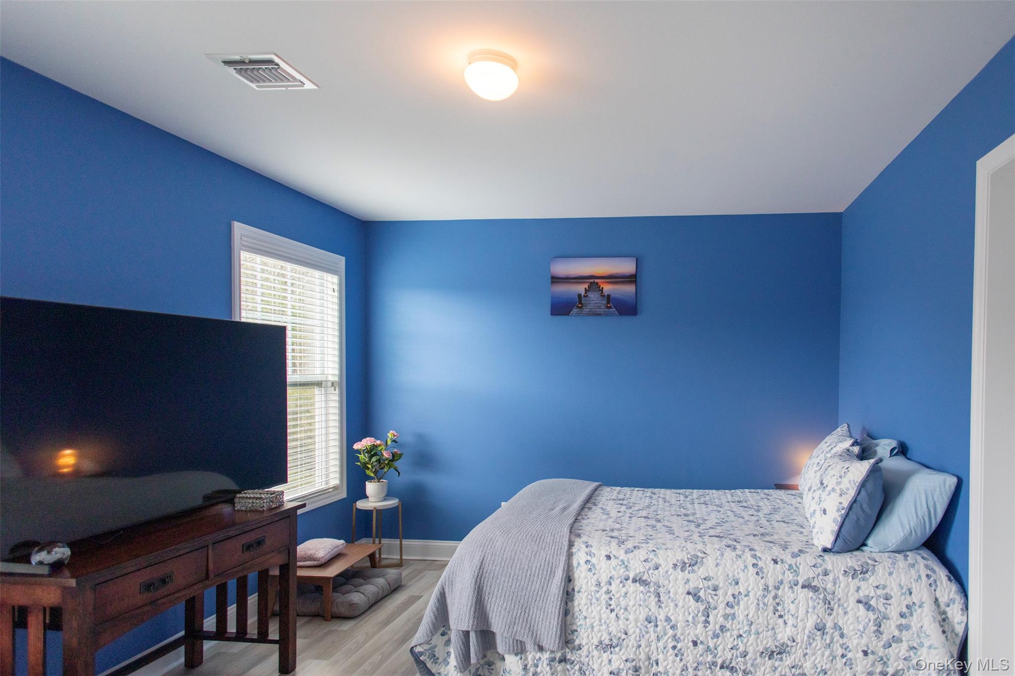 29 Wild Flower Drive Ridge, NY 11961 - Photo 19 of 45 a bedroom with a bed and a flat screen tv