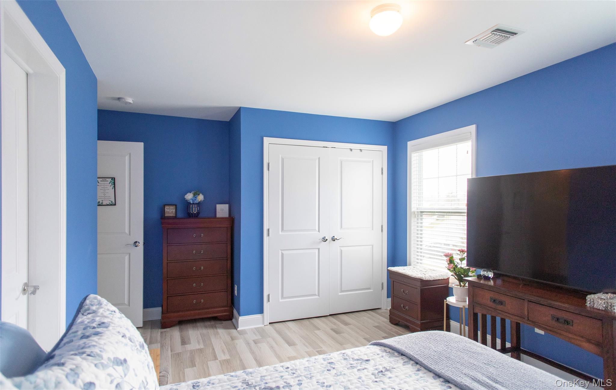 29 Wild Flower Drive Ridge, NY 11961 - Photo 20 of 45 a living room with furniture and a flat screen tv