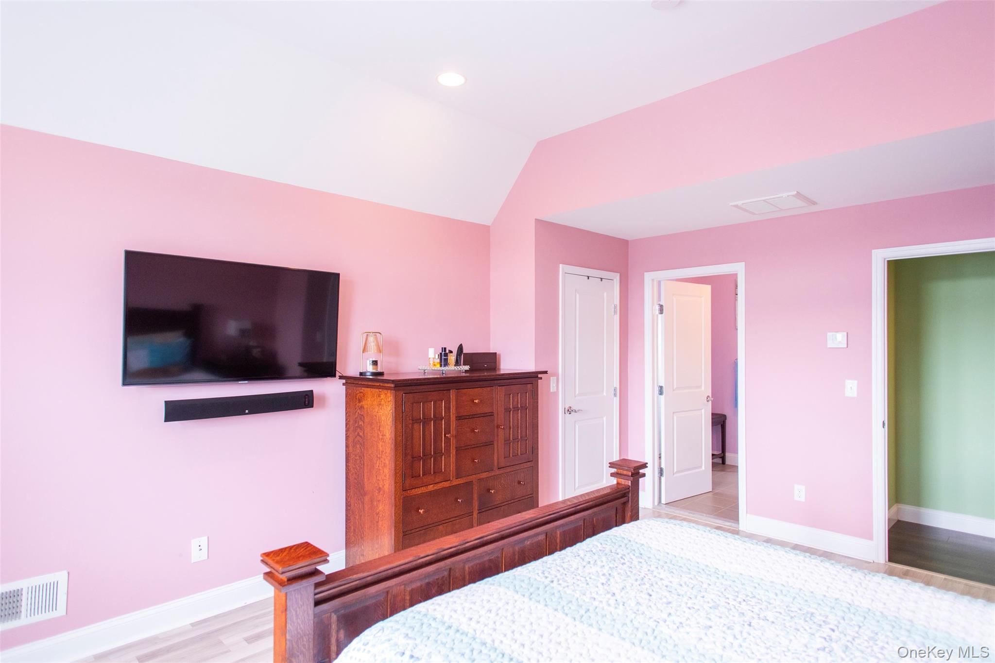 29 Wild Flower Drive Ridge, NY 11961 - Photo 22 of 45 a bedroom with a bed and a flat screen tv