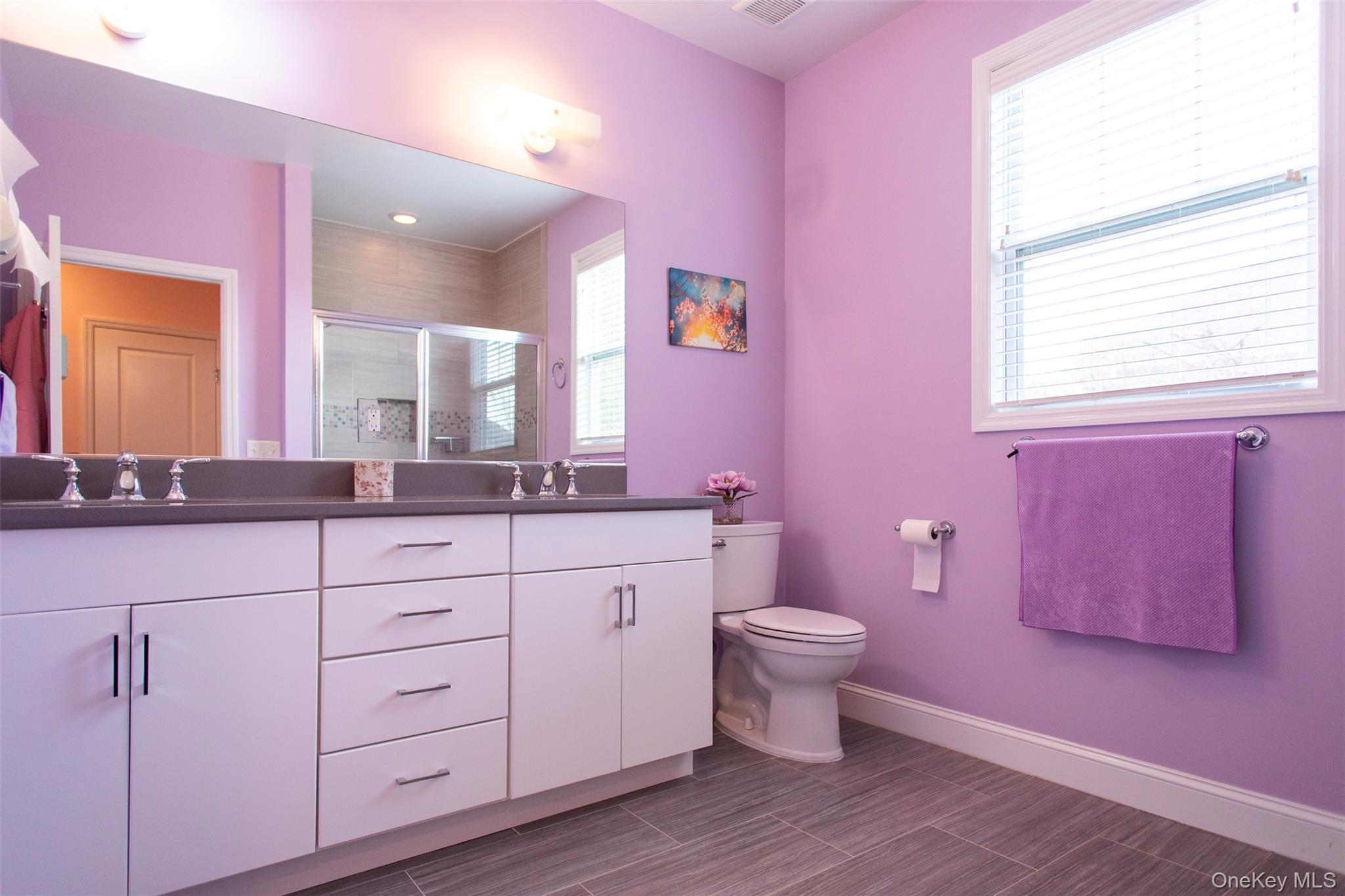 29 Wild Flower Drive Ridge, NY 11961 - Photo 25 of 45 a bathroom with a sink a toilet a mirror and vanity