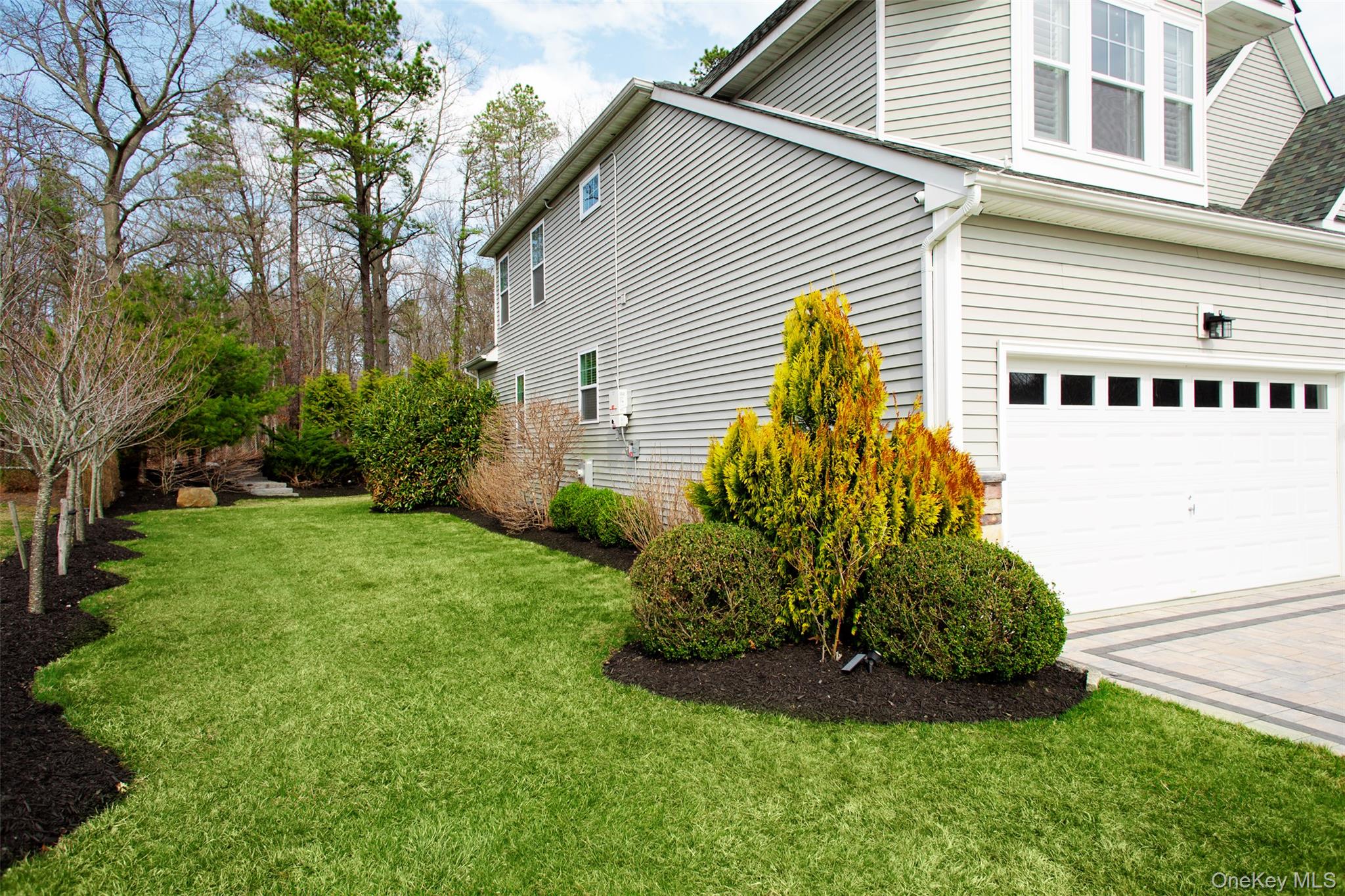 29 Wild Flower Drive Ridge, NY 11961 - Photo 4 of 45 a view of a house with a backyard and a garage