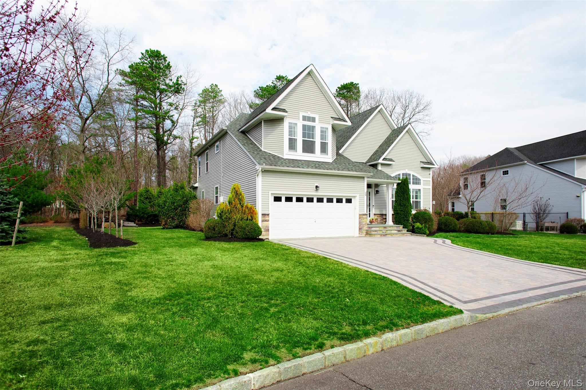 29 Wild Flower Drive Ridge, NY 11961 - Photo 44 of 45 a front view of a house with a yard and garage