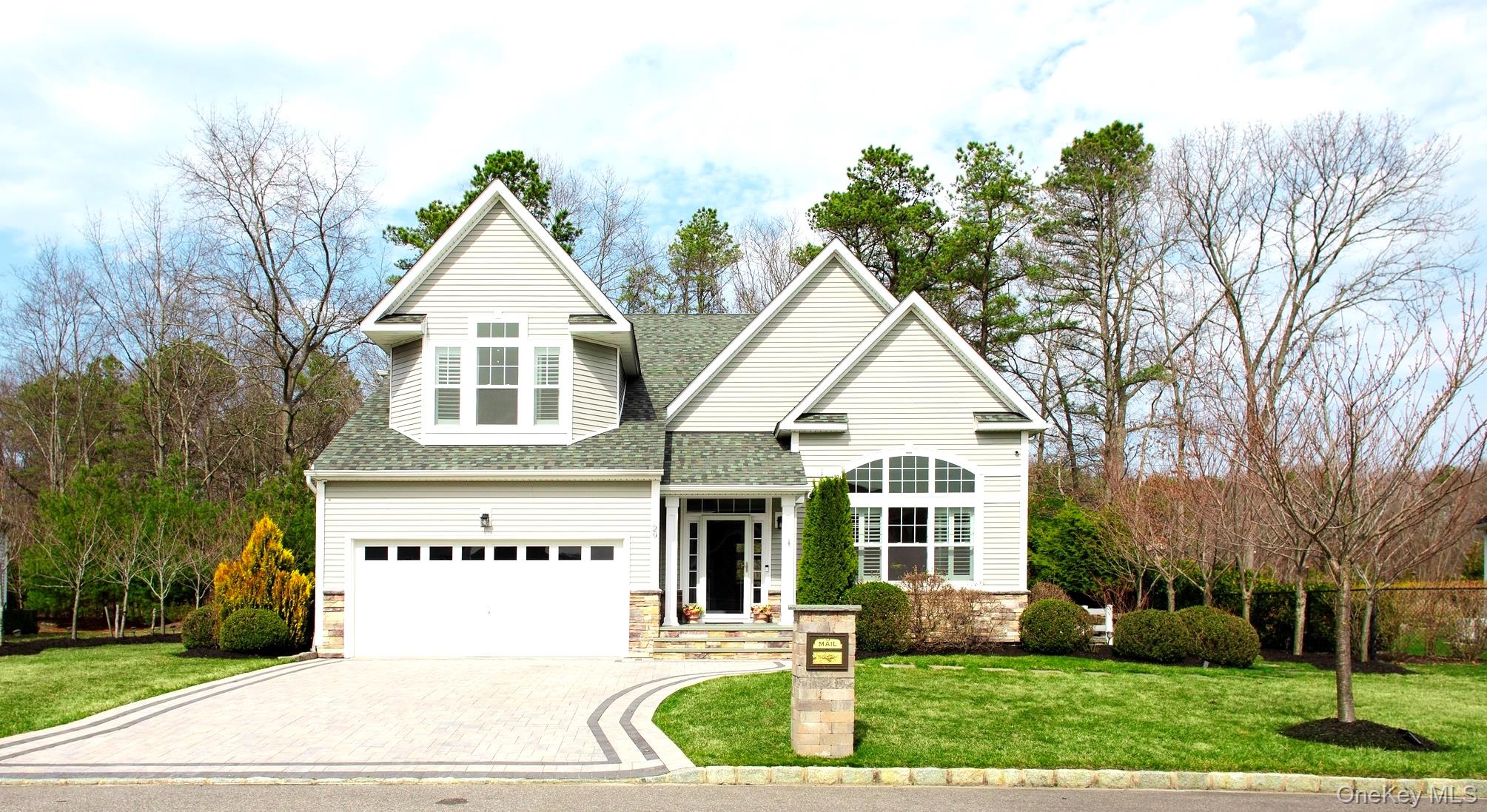 29 Wild Flower Drive Ridge, NY 11961 - Photo 45 of 45 a view of a white house next to a yard with big trees