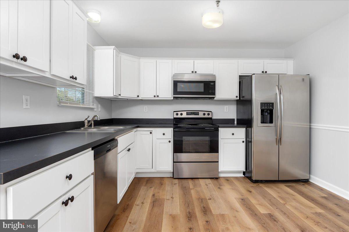 334 East Baltimore Street Taneytown, MD 21787 - Photo 5 of 31 a kitchen with stainless steel appliances a sink dishwasher a refrigerator and a stove