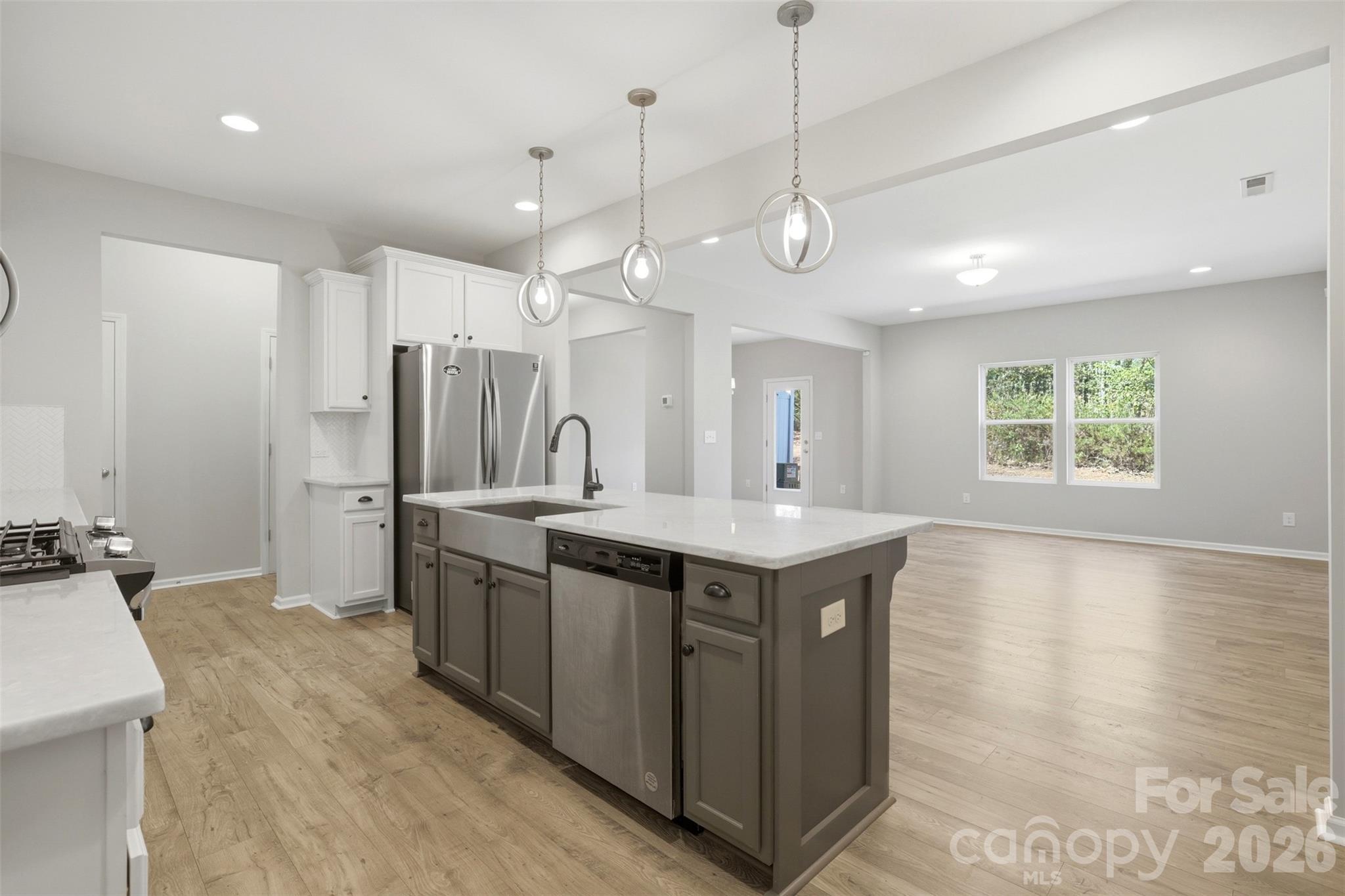 1117 Streamside Lane York, SC 29745 - Photo 4 of 25 a large kitchen with a large counter top a sink stainless steel appliances and cabinets
