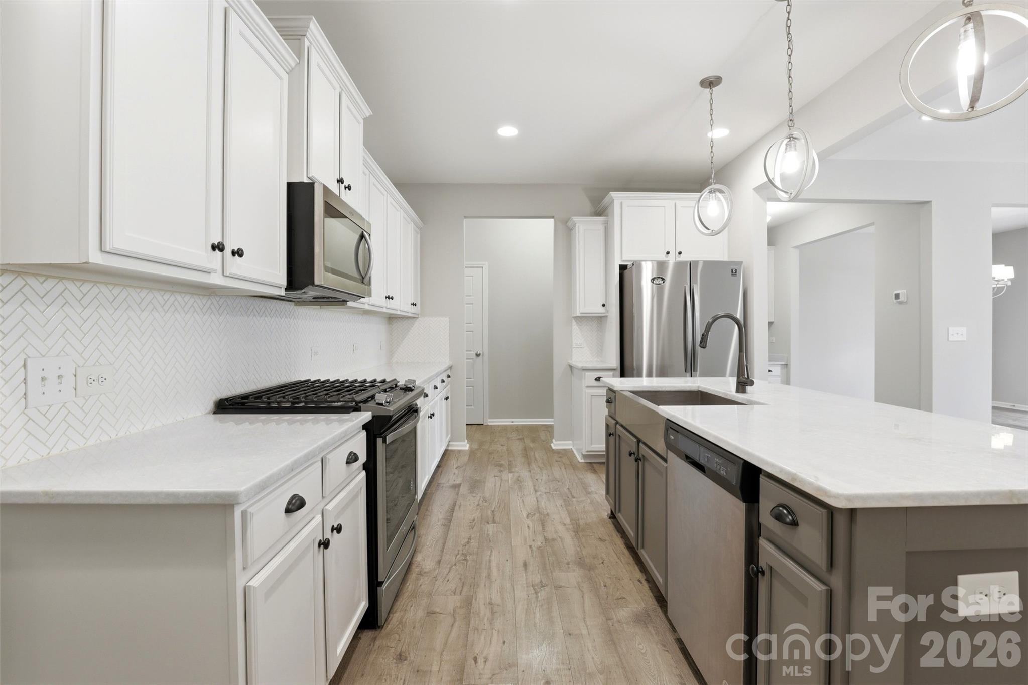 1117 Streamside Lane York, SC 29745 - Photo 5 of 25 a kitchen with stainless steel appliances granite countertop a sink and a stove