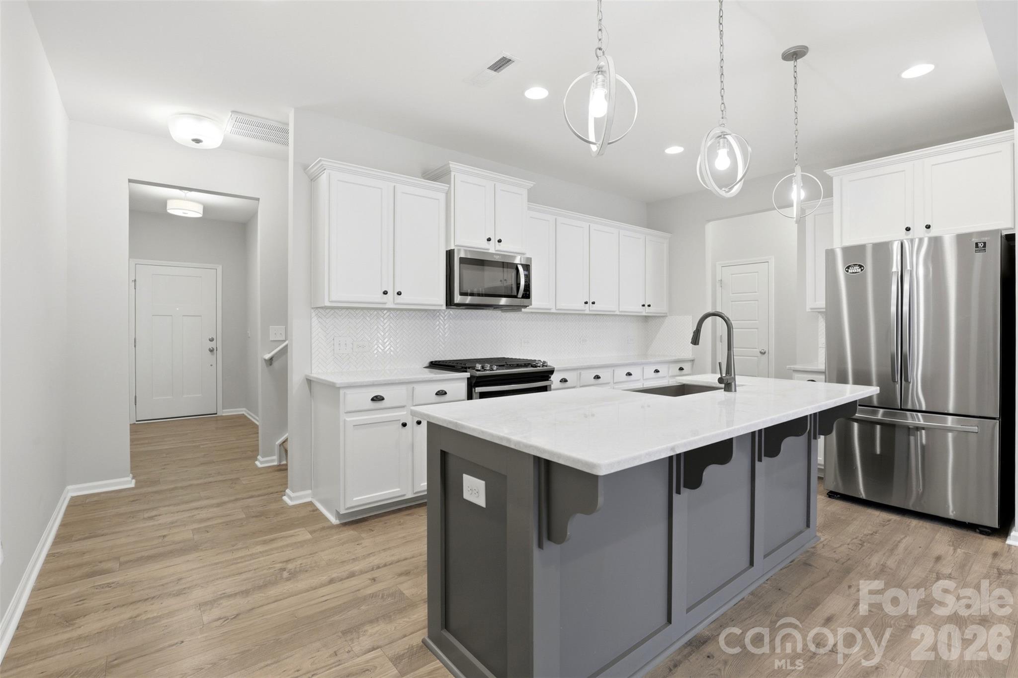 1117 Streamside Lane York, SC 29745 - Photo 6 of 25 a kitchen with kitchen island a sink stainless steel appliances and cabinets
