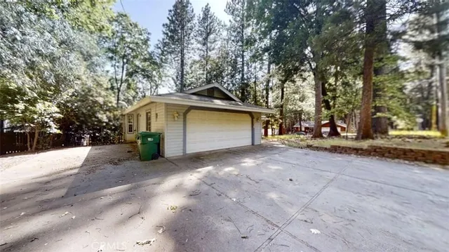a view of a house with a outdoor space and tree