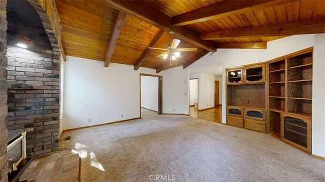 a view of an empty room with a fireplace