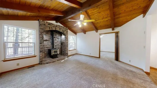 a view of a hallway with wooden floor and a living room
