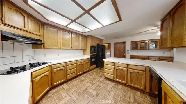 a kitchen with stainless steel appliances granite countertop a sink and cabinets