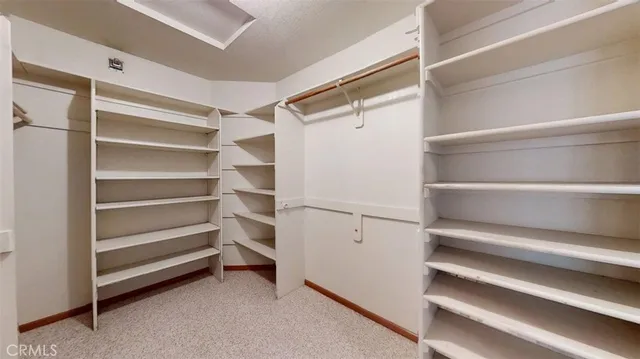 a view of a hallway with wooden floor and entryway