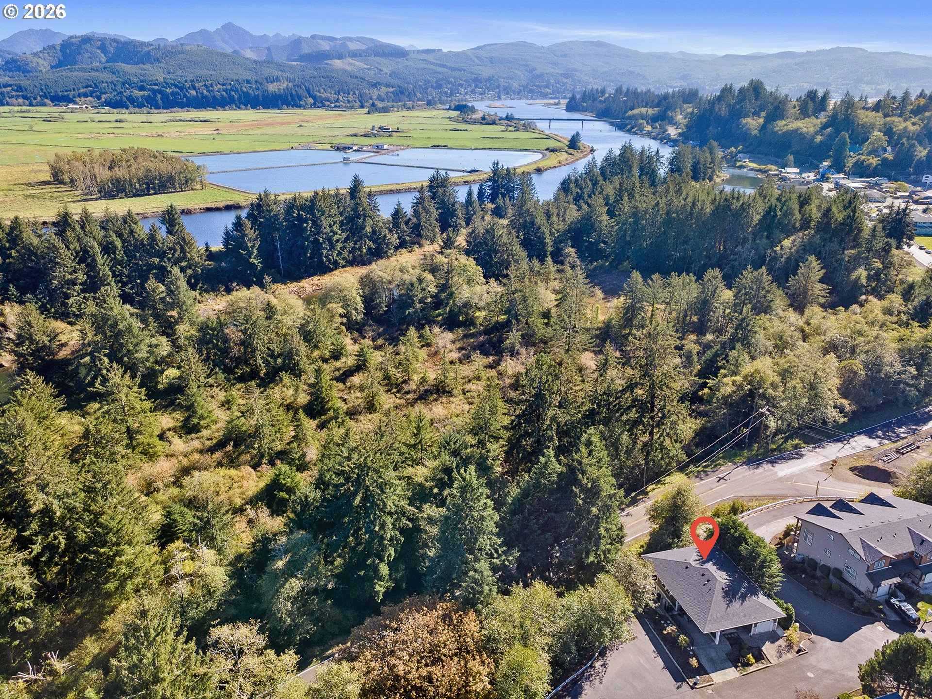 an aerial view of a house with a lake view
