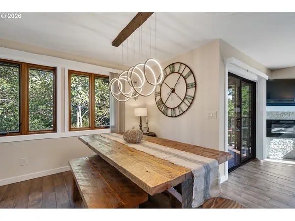 a living room with a large window and a clock
