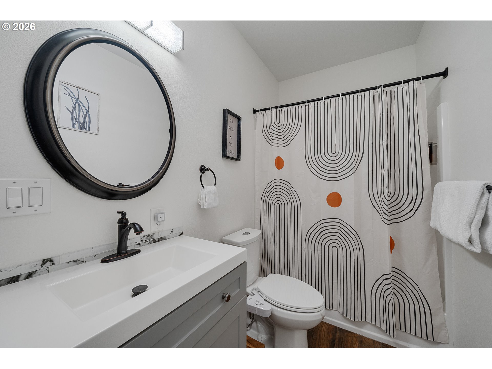 13150 D Street, Unit 8 Nehalem, OR 97131 - Photo 23 of 28 a bathroom with a sink a mirror a toilet and a mirror