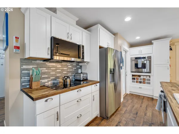 a kitchen with stainless steel appliances granite countertop a refrigerator sink and microwave