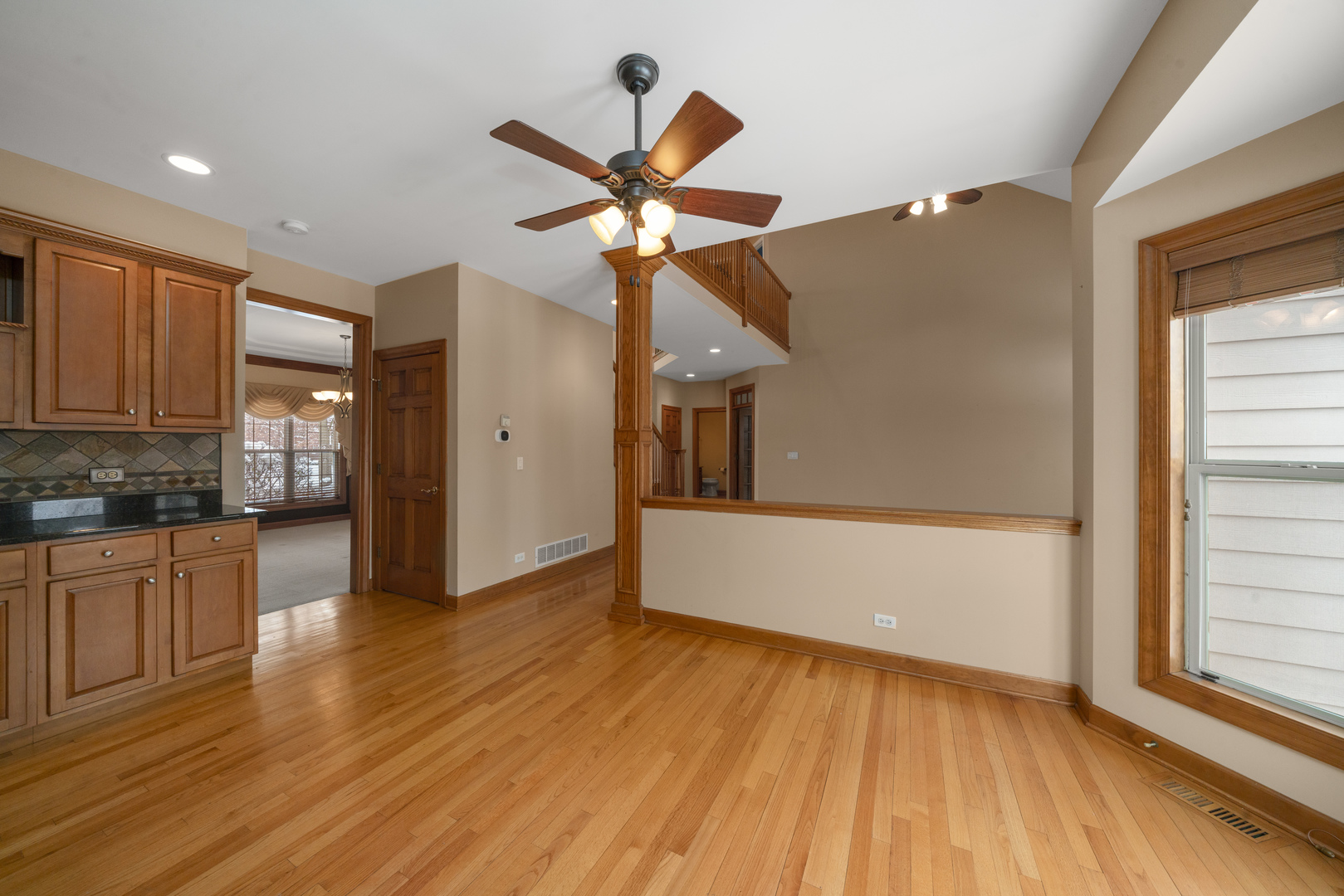 757 Merrill New Road Sugar Grove, IL 60554 - Photo 11 of 51 a view of a kitchen with wooden floor and a ceiling fan