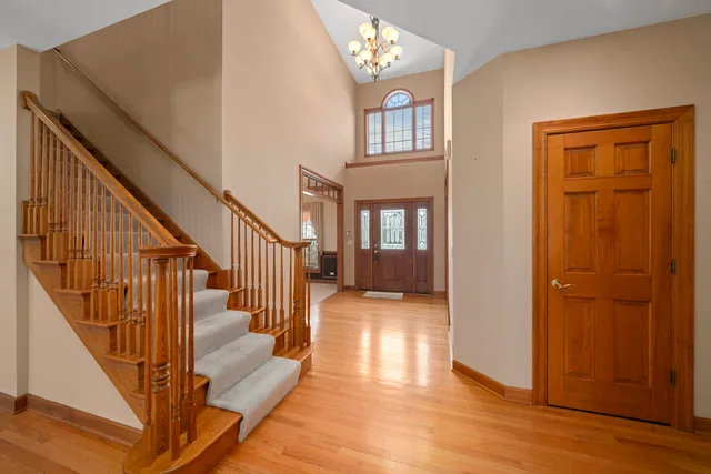 a view of entryway and hall with wooden floor