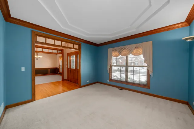 a view of an empty room with a window and a bedroom