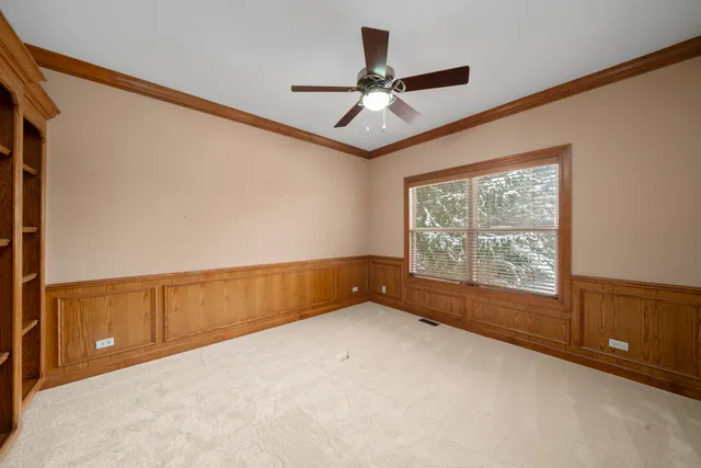 a view of an empty room with a ceiling fan