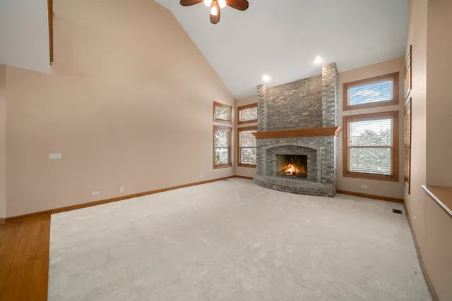 an empty room with fireplace and window