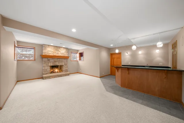 a kitchen with stainless steel appliances granite countertop a sink a refrigerator and a stove