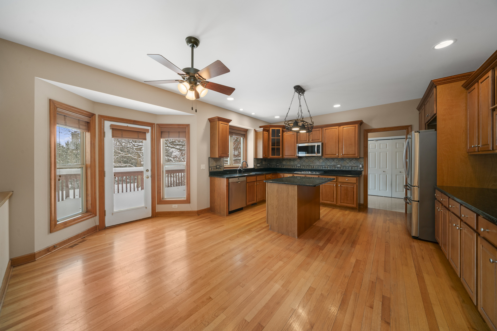 757 Merrill New Road Sugar Grove, IL 60554 - Photo 5 of 51 a kitchen with stainless steel appliances kitchen island granite countertop a stove top oven a sink and a refrigerator