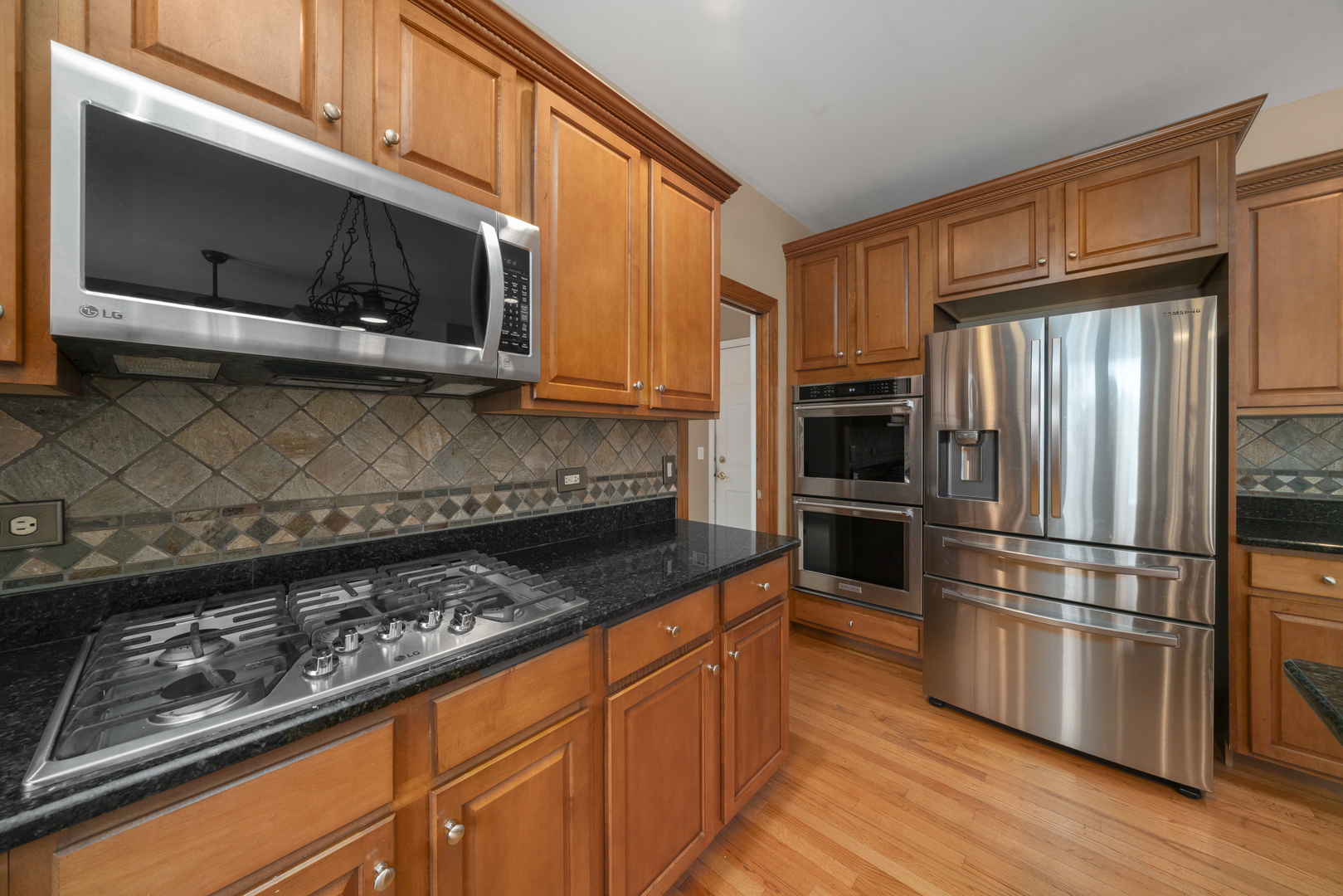 757 Merrill New Road Sugar Grove, IL 60554 - Photo 10 of 51 a kitchen with granite countertop a refrigerator stove and microwave