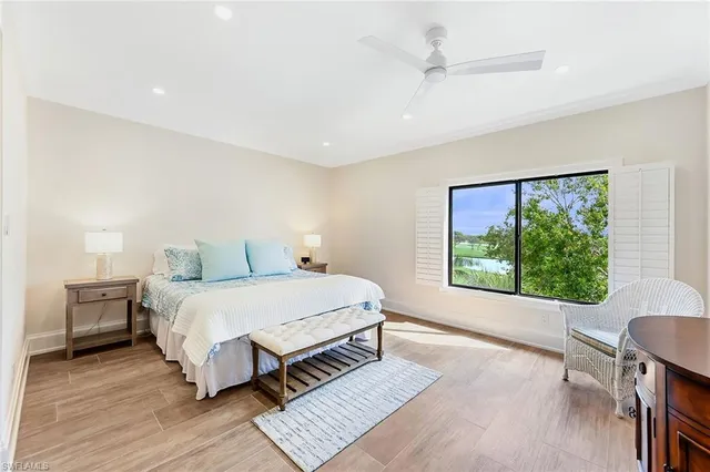 a spacious bedroom with a large bed and a large window