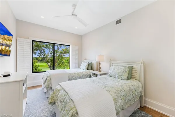 a bedroom with a bed and a large window