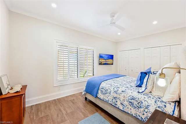 a bedroom with a large bed and a window