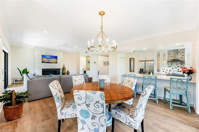 a view of a dining room with furniture wooden floor and chandelier