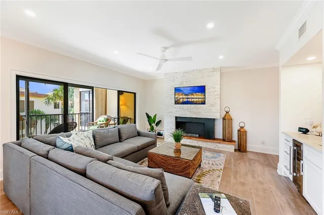 a living room with fireplace furniture and a wooden floor