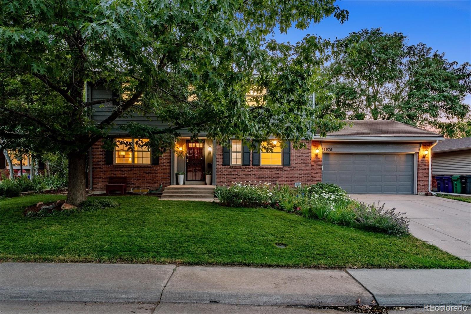 1975 South Locust Street Denver, CO 80224 - Photo 1 of 40 a front view of a house with a yard