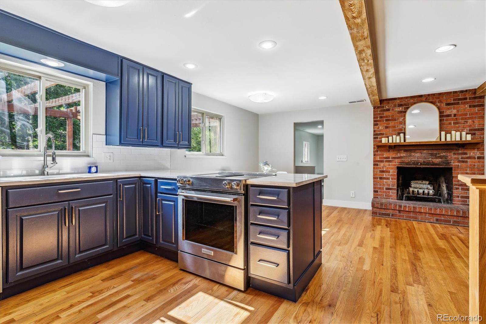 1975 South Locust Street Denver, CO 80224 - Photo 16 of 40 a kitchen with stainless steel appliances granite countertop a stove a sink and a microwave
