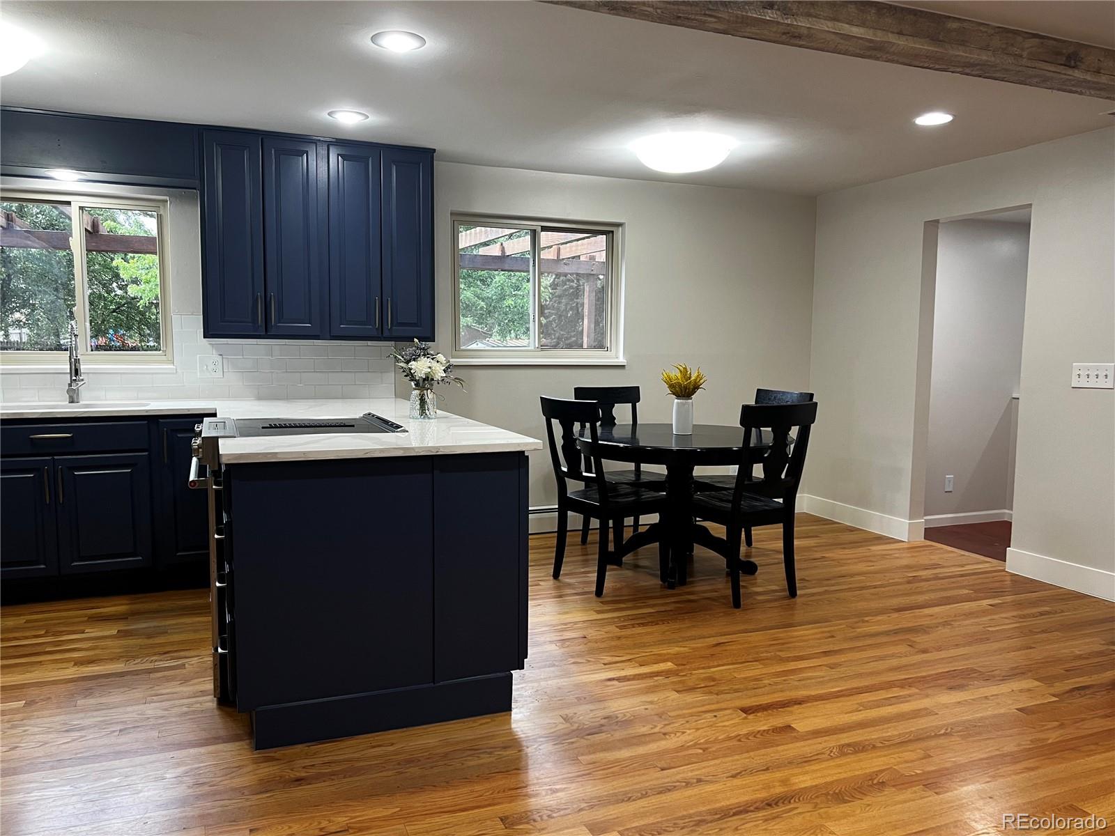 1975 South Locust Street Denver, CO 80224 - Photo 18 of 40 a kitchen with a table chairs and wooden floor