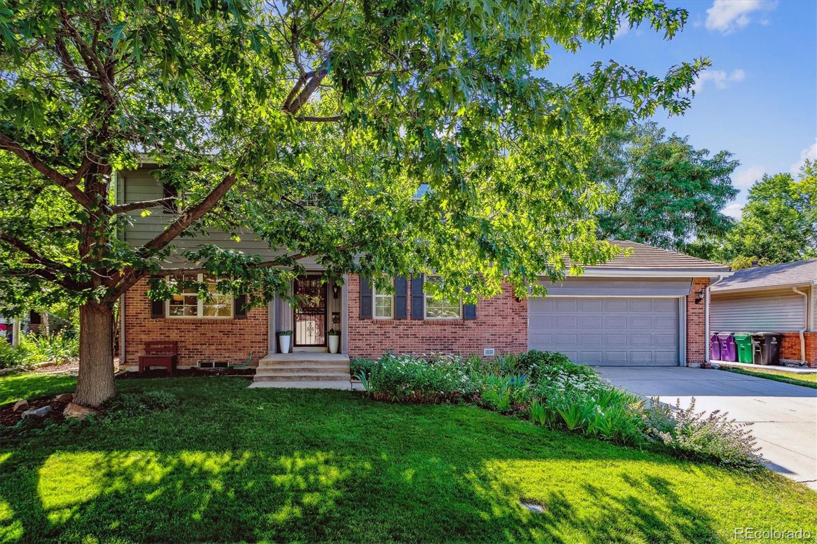1975 South Locust Street Denver, CO 80224 - Photo 2 of 40 a front view of a house with a yard
