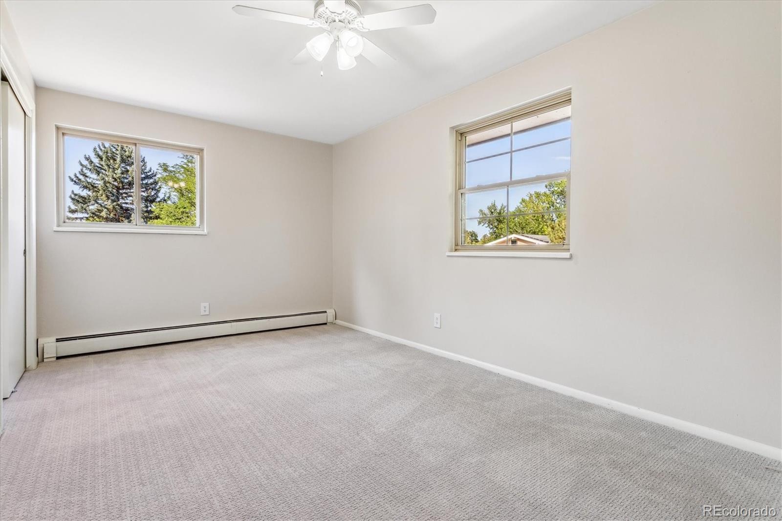1975 South Locust Street Denver, CO 80224 - Photo 24 of 40 an empty room with windows and fan