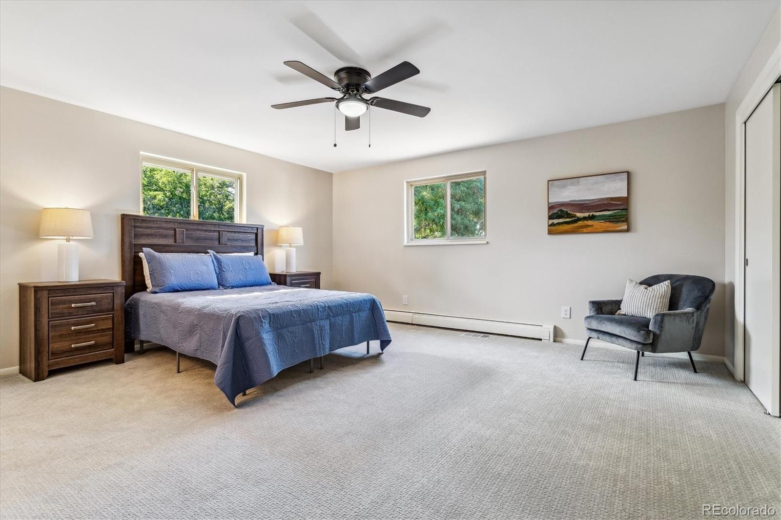 1975 South Locust Street Denver, CO 80224 - Photo 25 of 40 a bedroom with a bed a chandelier and a window