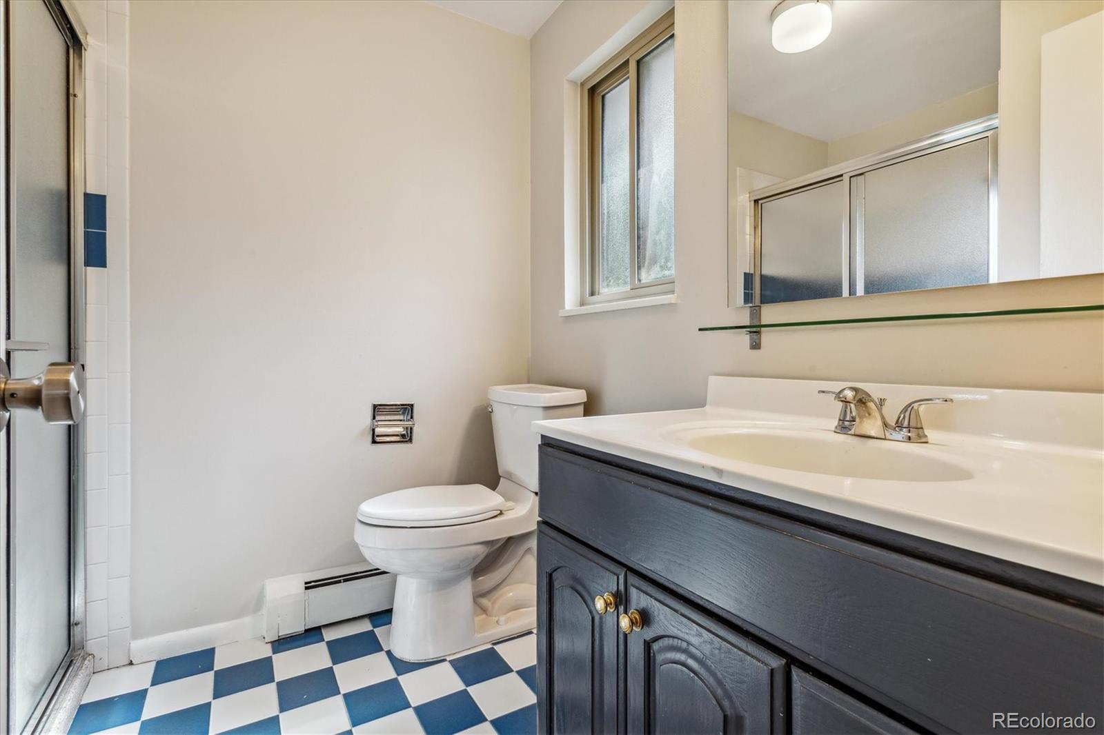 1975 South Locust Street Denver, CO 80224 - Photo 27 of 40 a bathroom with a sink and a toilet