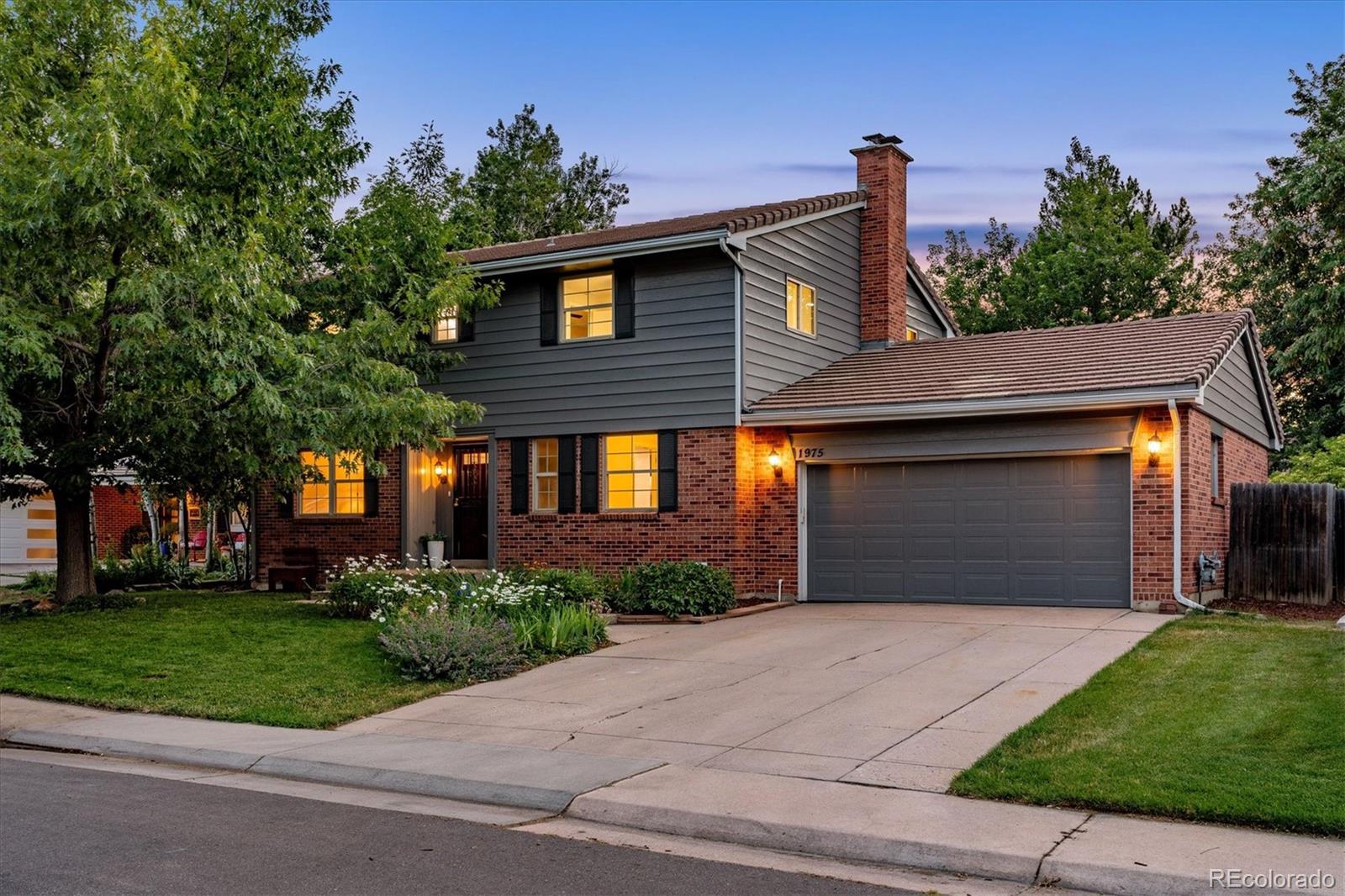1975 South Locust Street Denver, CO 80224 - Photo 3 of 40 a front view of a house with a garden and plants