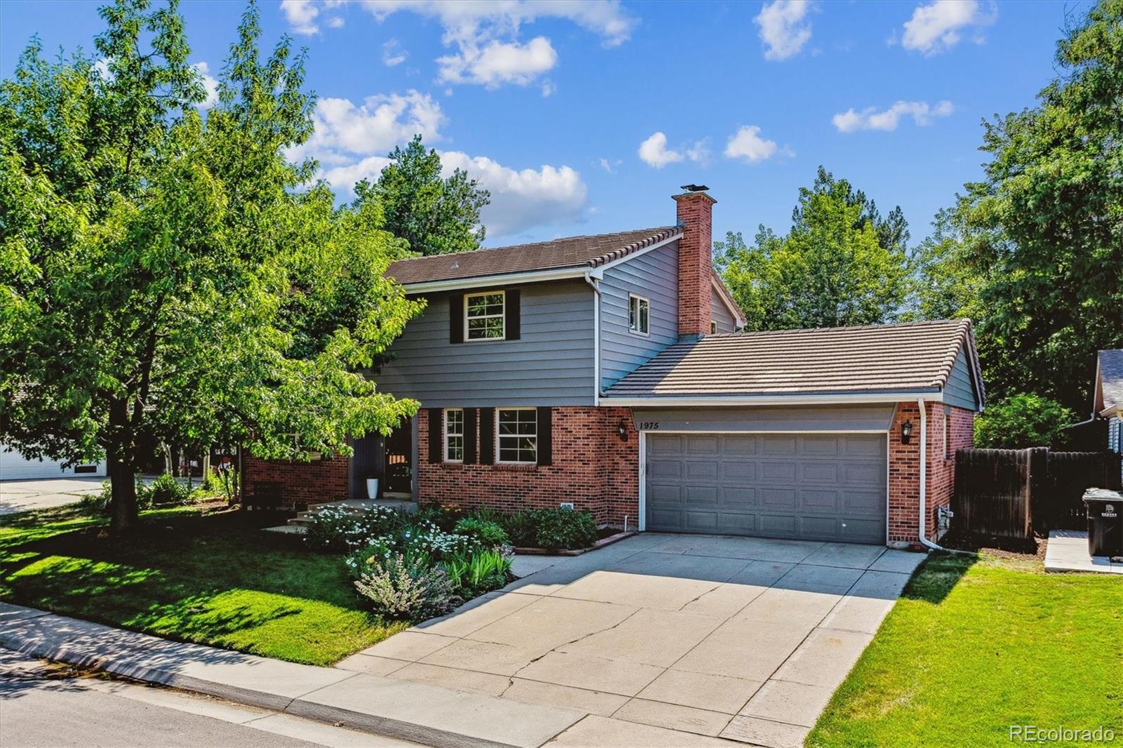 1975 South Locust Street Denver, CO 80224 - Photo 4 of 40 a front view of a house with a garden