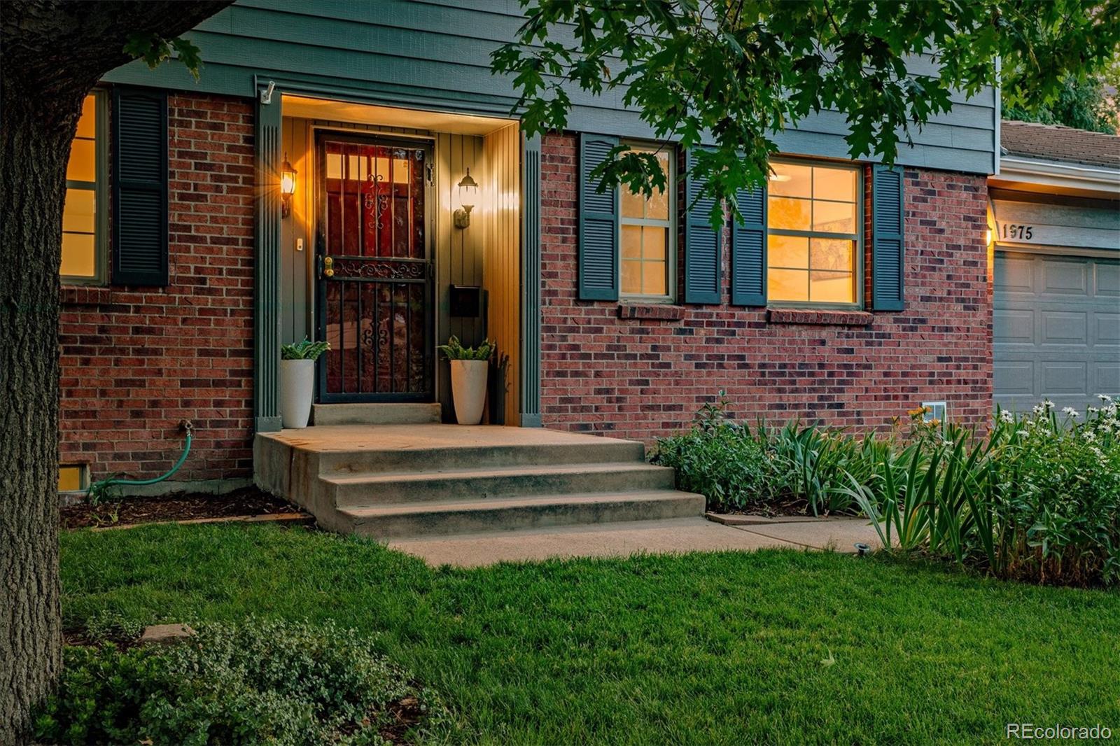 1975 South Locust Street Denver, CO 80224 - Photo 6 of 40 a front view of a house with a garden