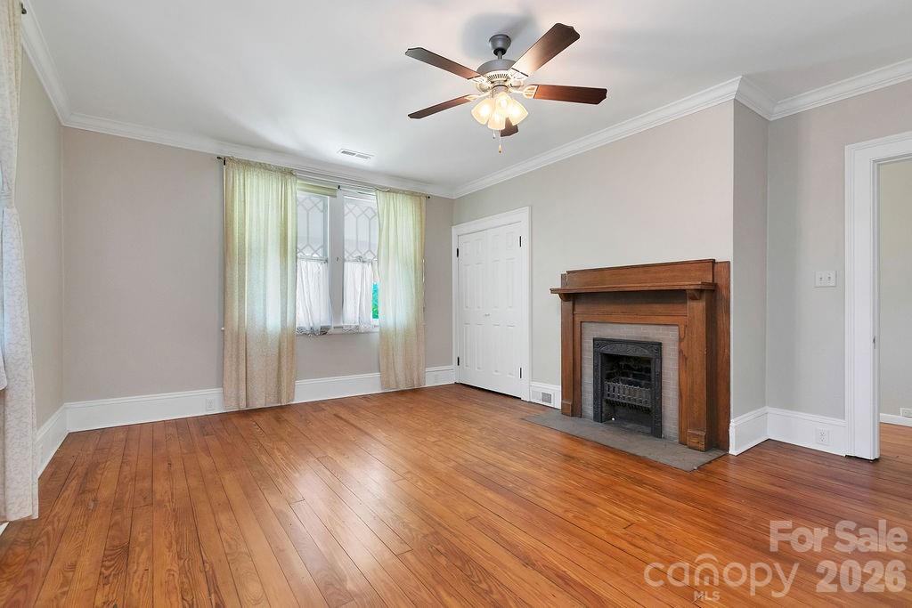 208 West Probart Street Brevard, NC 28712 - Photo 38 of 48 a view of an empty room with wooden floor and a window